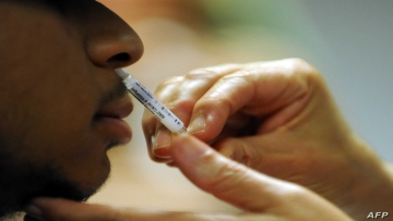 (FILES) In this file photo taken on October 09, 2009, a patient receives a nasal spray vaccine for the H1N1 virus during a clinic held by Montgomery County Health and Human Services at the Dennis Avenue County Health Center in Silver Spring, Maryland. - Global influenza vaccine makers have produced a record number of doses for the coming flu season, as authorities try to ease the burden on hospitals ahead of an expected COVID-19 resurgence. In the US, pharmaceutical companies plan to make around 196 million doses to serve the population of 330 million, according to the Centers for Disease Control and Prevention (CDC). (Photo by Tim SLOAN / AFP)